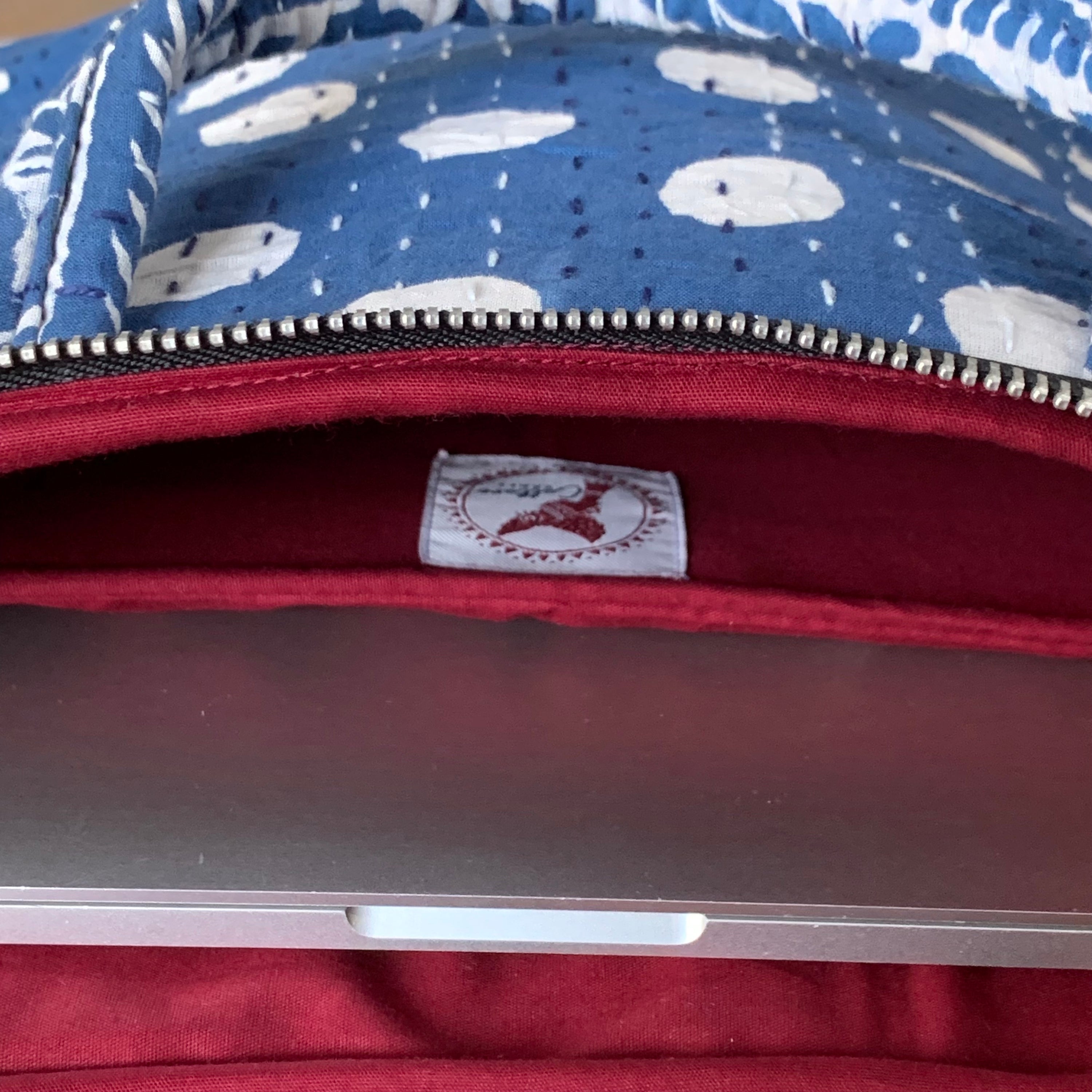 "Indigo laptop bag with Dabu handblock print, featuring intricate patterns and sturdy handles for a stylish and functional design."