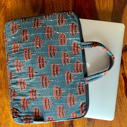 Jhumar Ajrakh handblock printed laptop bag featuring intricate traditional patterns in earthy tones, showcasing a spacious design with sturdy handles and a stylish appearance, perfect for carrying laptops and essentials.